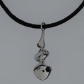 Silver necklace suspended on black silk