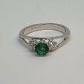 Emerald and diamond white gold engagement ring