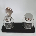 Silver inkwells showing the hinged lid