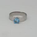 Platinum and blue topaz ring