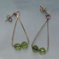 Linear earrings with peridot beads